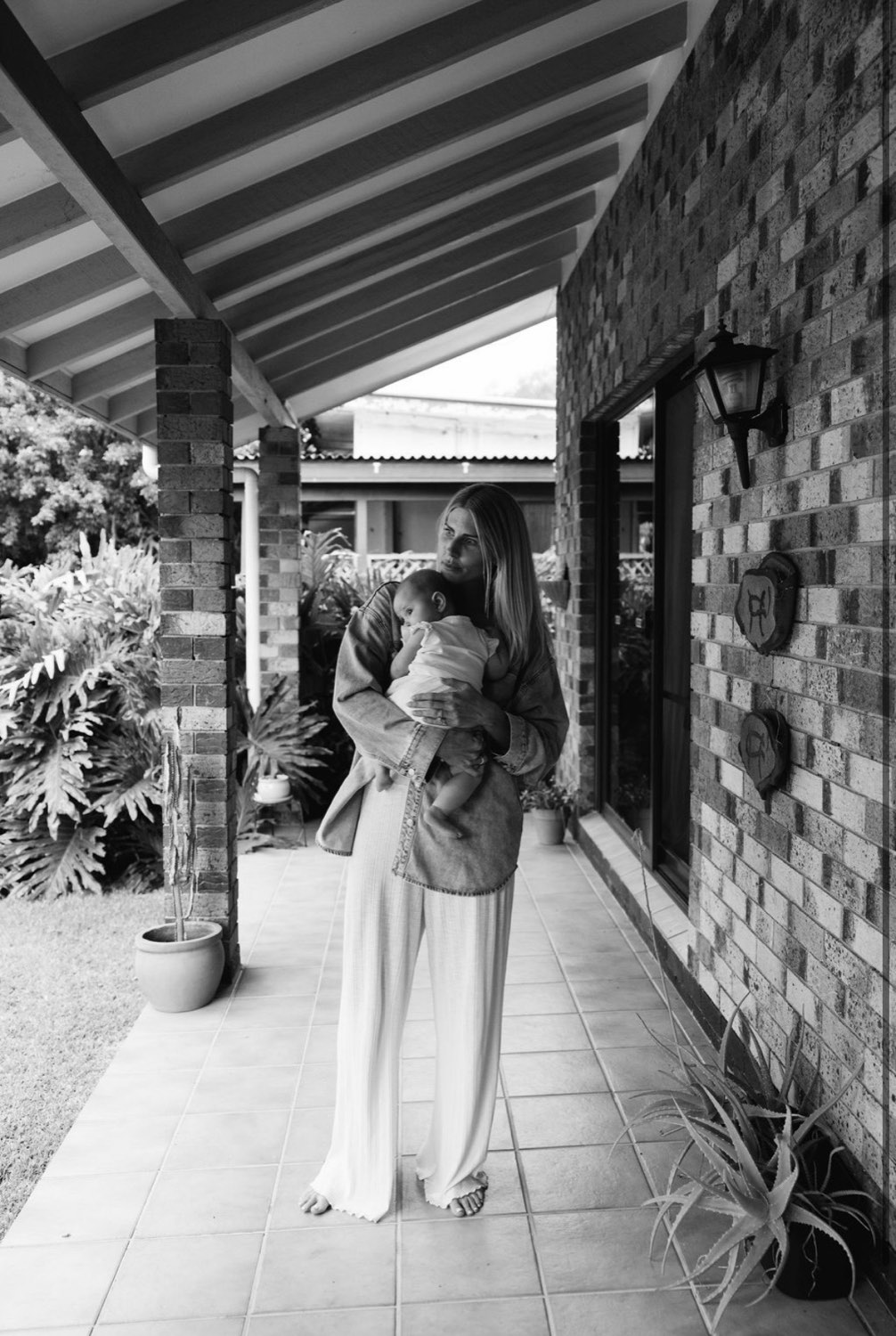 Mother holding her baby at home